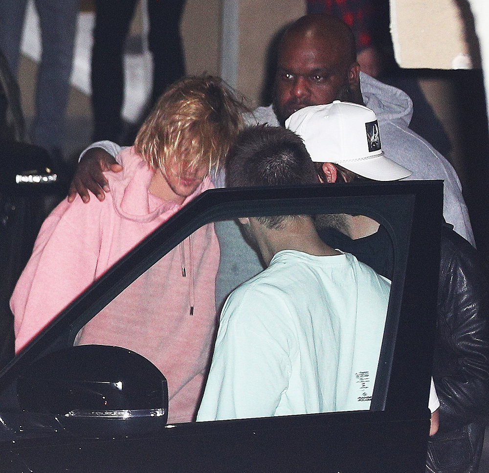 Justin Bieber embraced by friends